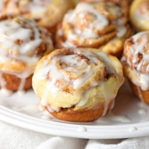 mini iced cinnamon rolls on a white plate