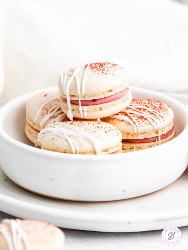 Raspberry macarons in a white bowl