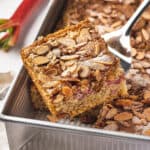 Overhead view of a spatula serving a slice of rhubarb coffee cake