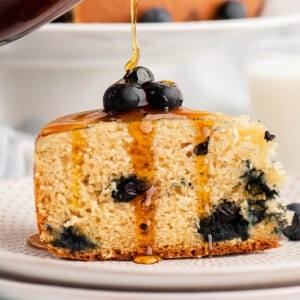 slice of rice cooker pancake with maple syrup being poured on top