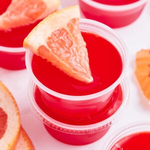 close up sea breeze jello shot garnished with a tiny grapefruit wedge
