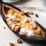 close up roasted banana with s'mores toppings