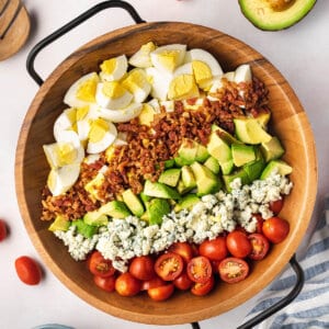 beautiful rows of cobb egg salad in wooden serving dish