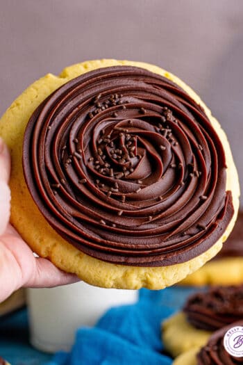 A hand holding a Crumbl chocolate cupcake cookie