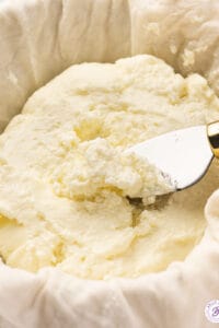 close up portion of homemade ricotta cheese on serving knife