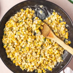overhead honey butter skillet corn in pan with wooden serving spoon