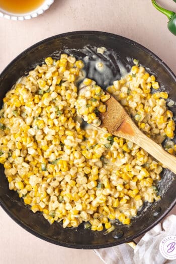 overhead honey butter skillet corn in pan with wooden serving spoon