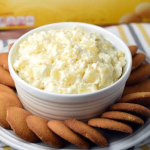 pineapple fruit dip in cup surrounded by nilla wafer cookies