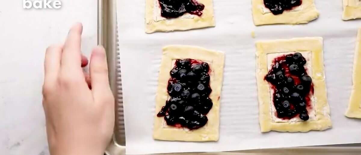 Jam and blueberries on the puff pastry rectangles.