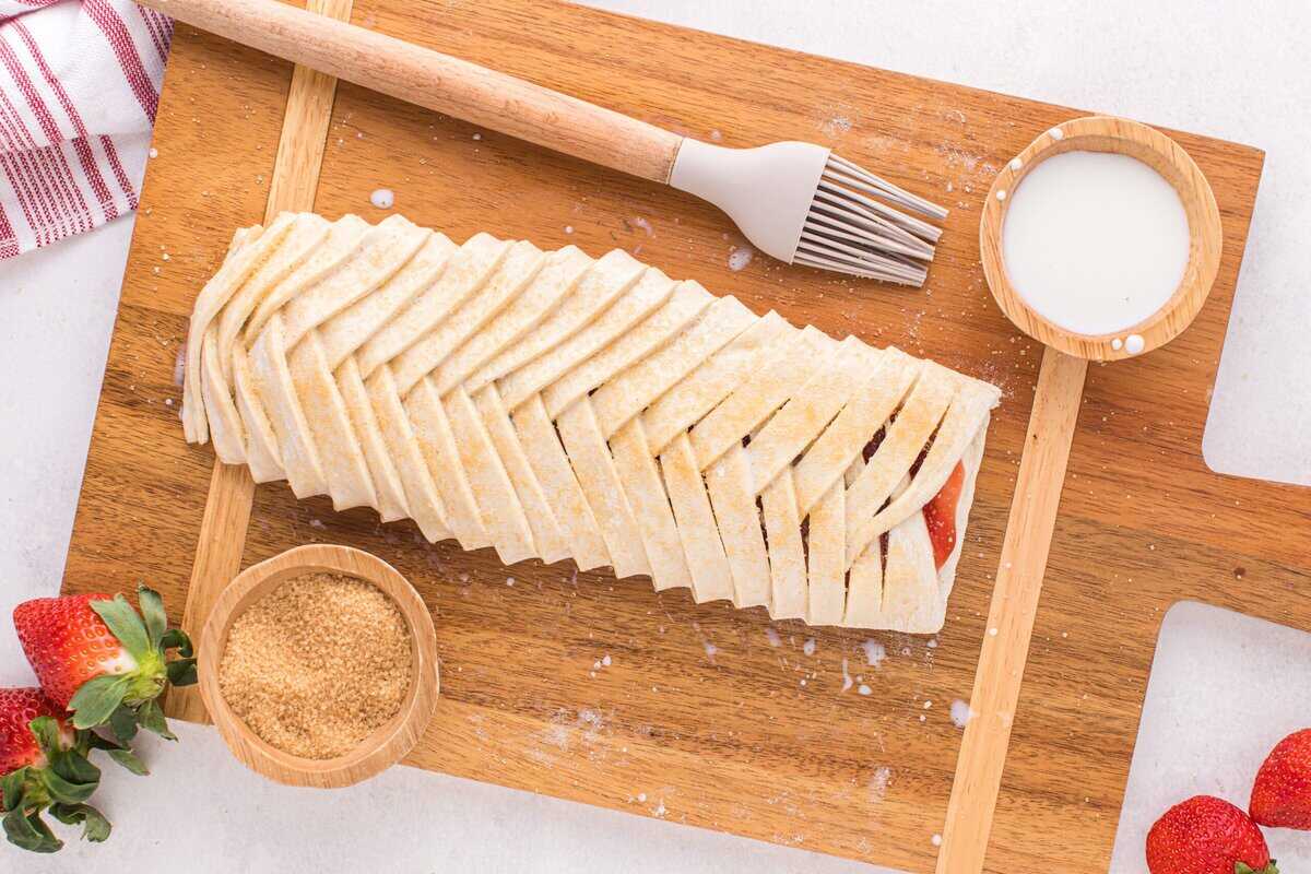 Slits of pastry folded over the cream cheese and strawberry jam filling.