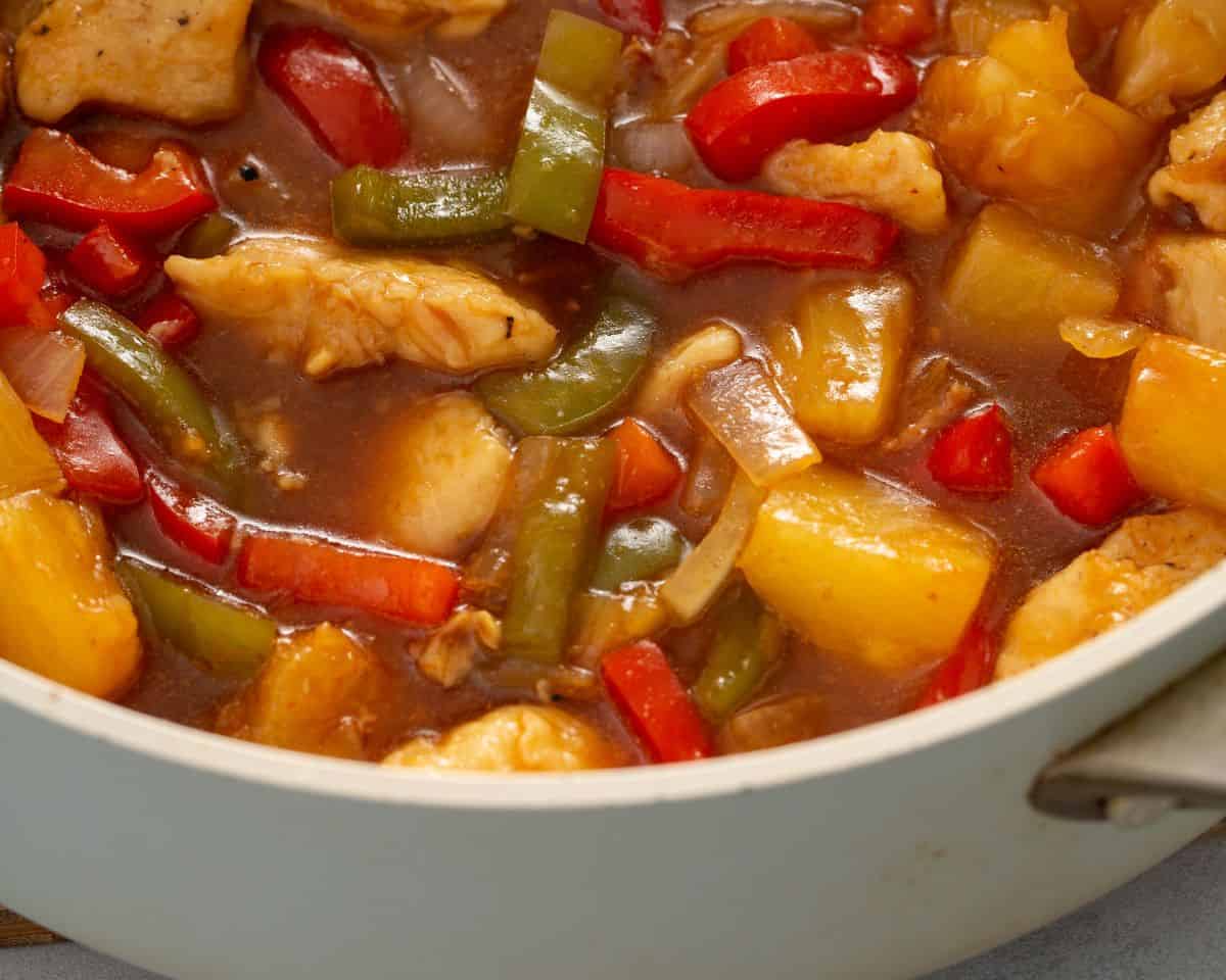 sweet and sour chicken simmering on stove