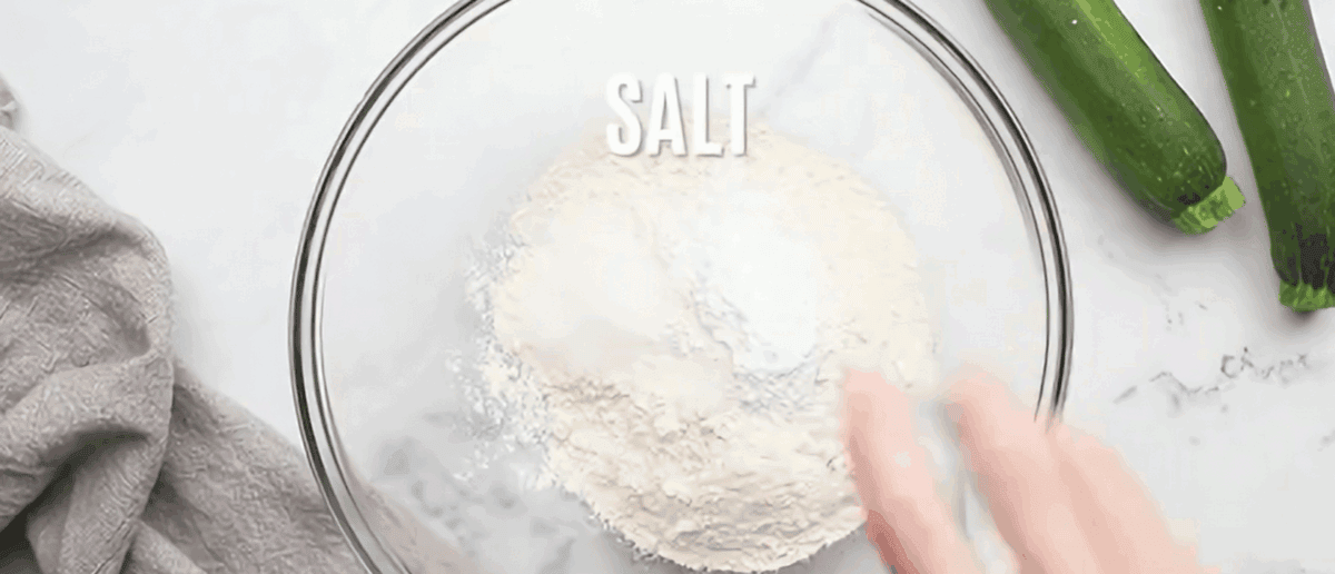 Combining dry ingredients for zucchini cheese bread.