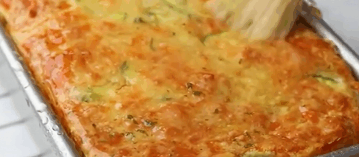 Brushing the zucchini bread with the topping.