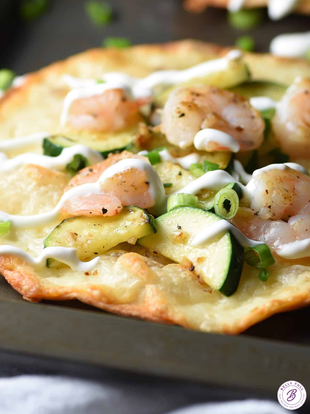 shrimp and zucchini on toasted tortilla with sour cream