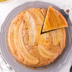 Overhead view of banana upside down cake with one slice cut