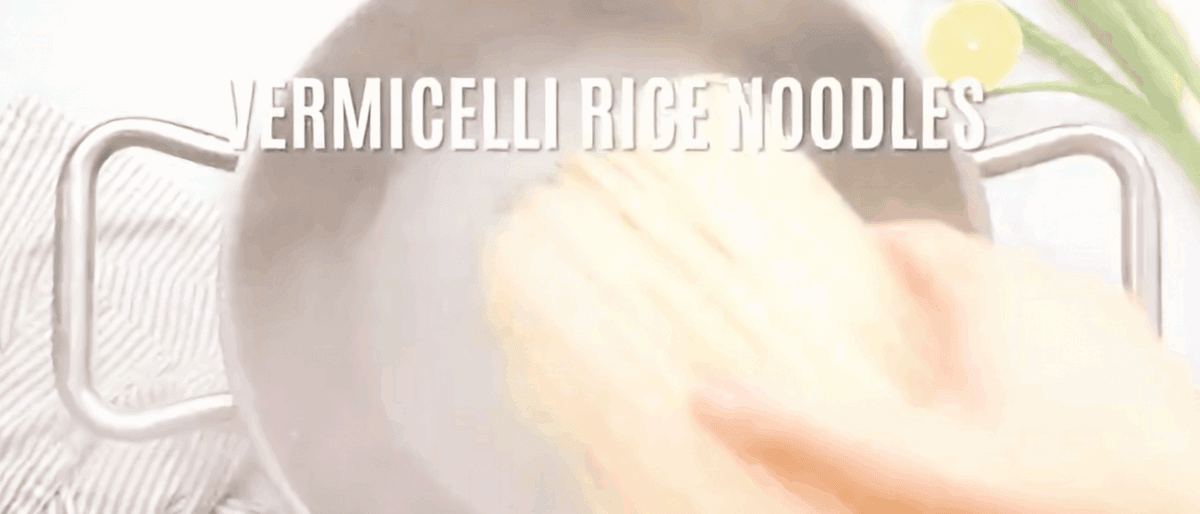 Cooking rice noodles in a pot filled with water.