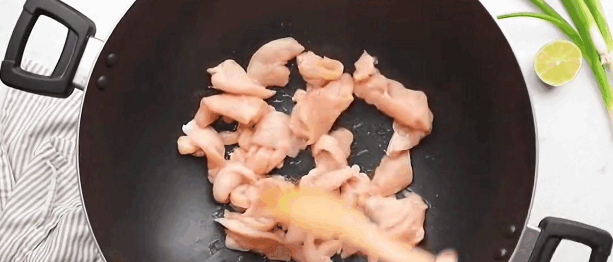 Cooking chicken in a wok.