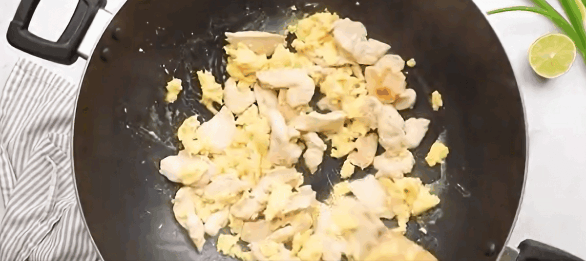 Chicken added back to the wok with the eggs.