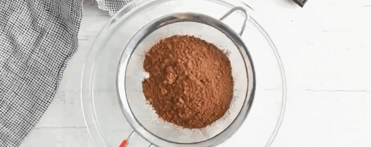 Sifting powdered sugar and cocoa powder.