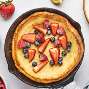 dutch baby pancake in skillet with fresh fruit
