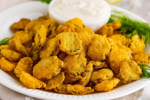 fried pickles on plate with dipping sauce