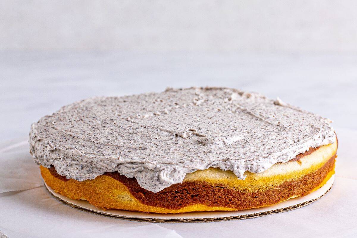 Bottom half of the layer cake with icing on top.