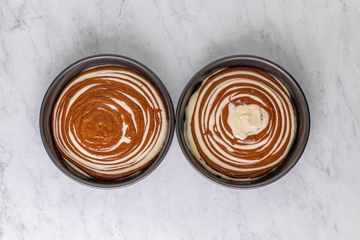Two cakes with vanilla and chocolate batter swirled.
