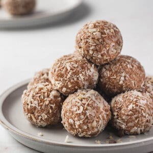 tall pile of almond joy energy balls on plate