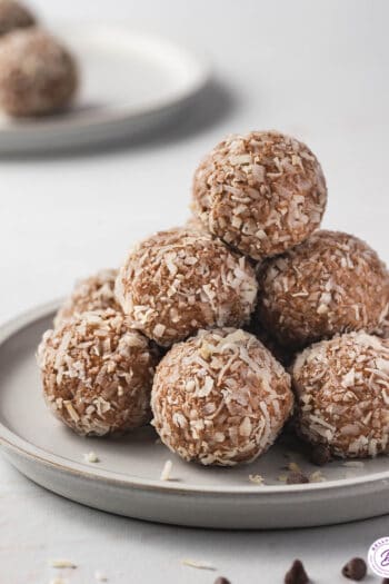 tall pile of almond joy energy balls on plate