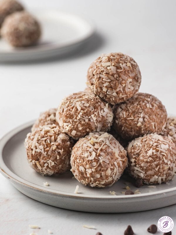 tall pile of almond joy energy balls on plate