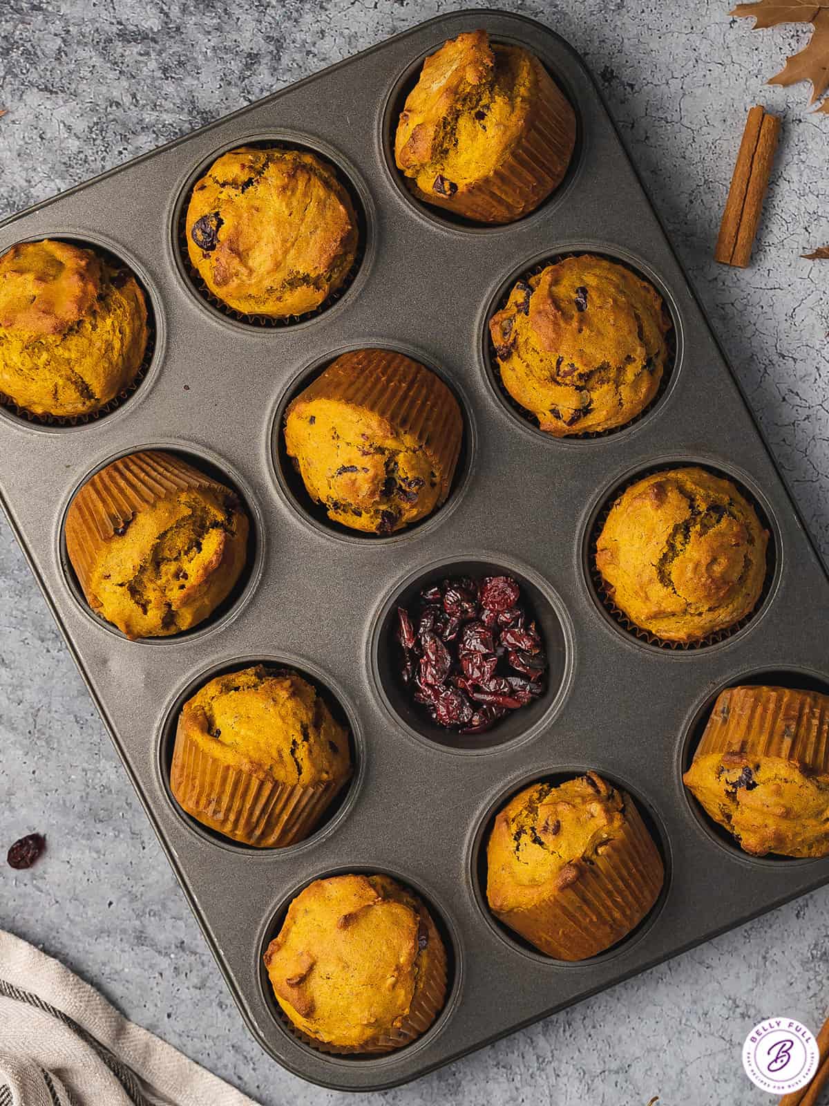 cranberry pumpkin muffins in muffin tin