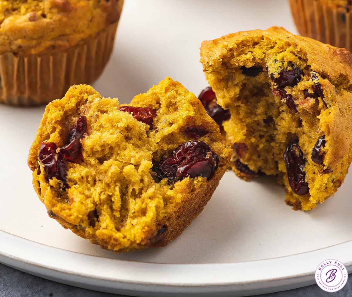 close up pumpkin cranberry muffin split in half