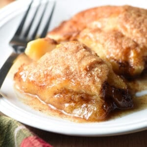 apple dumplings on white plate with fork