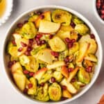 roasted brussels sprouts with apples and pomegranate seeds in bowl