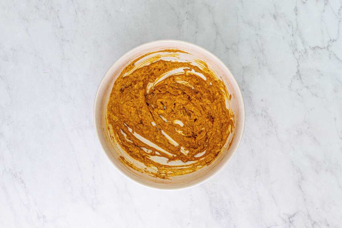 Chicken marinade in a white bowl.