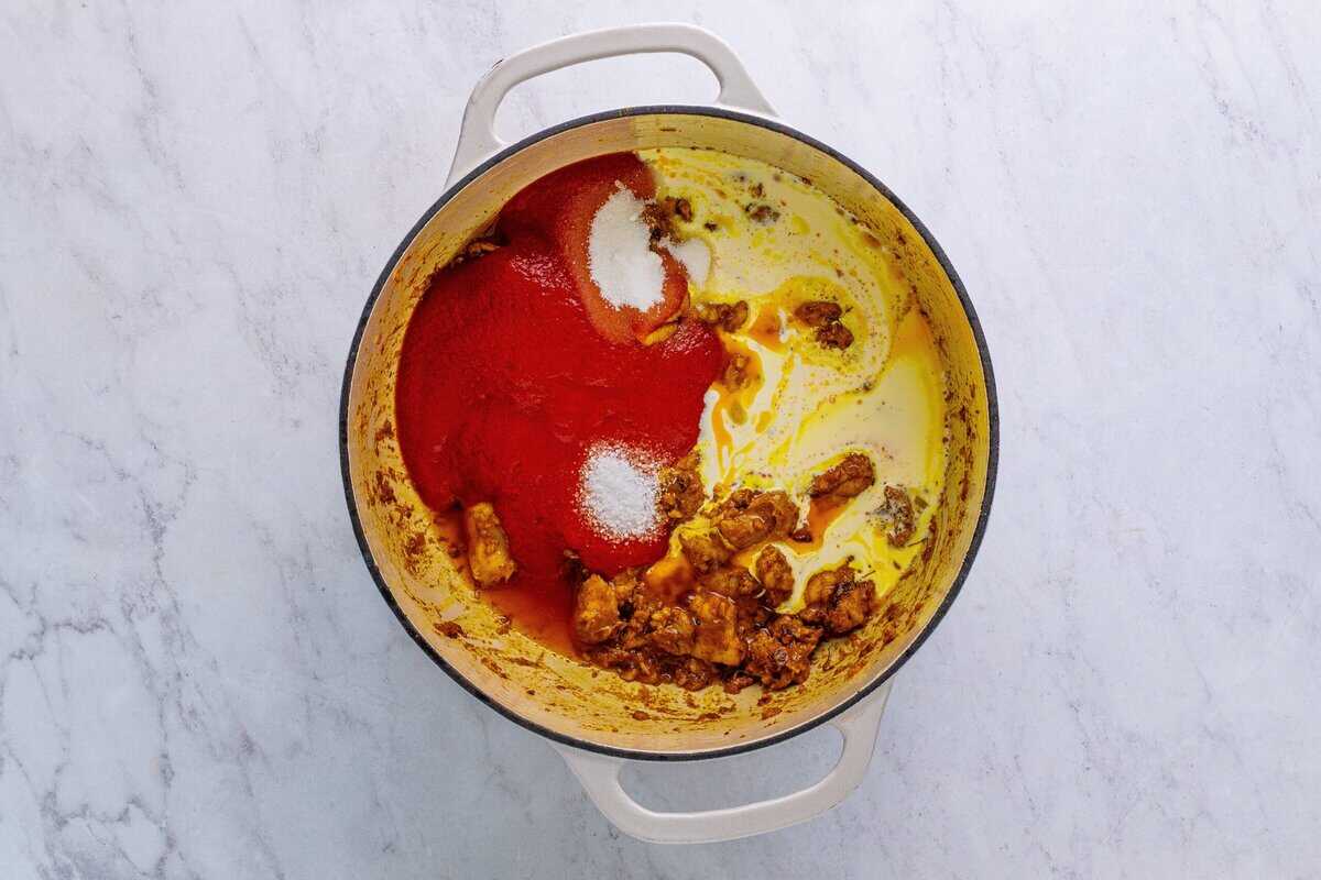 Adding the sauce ingredients to the Dutch oven.