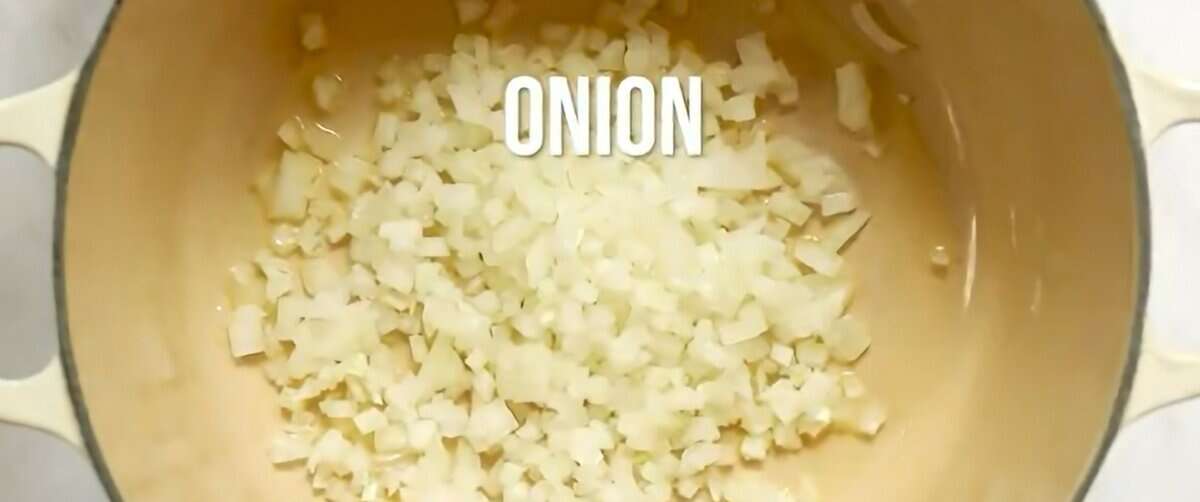 Cooking chopped onion in a skillet.