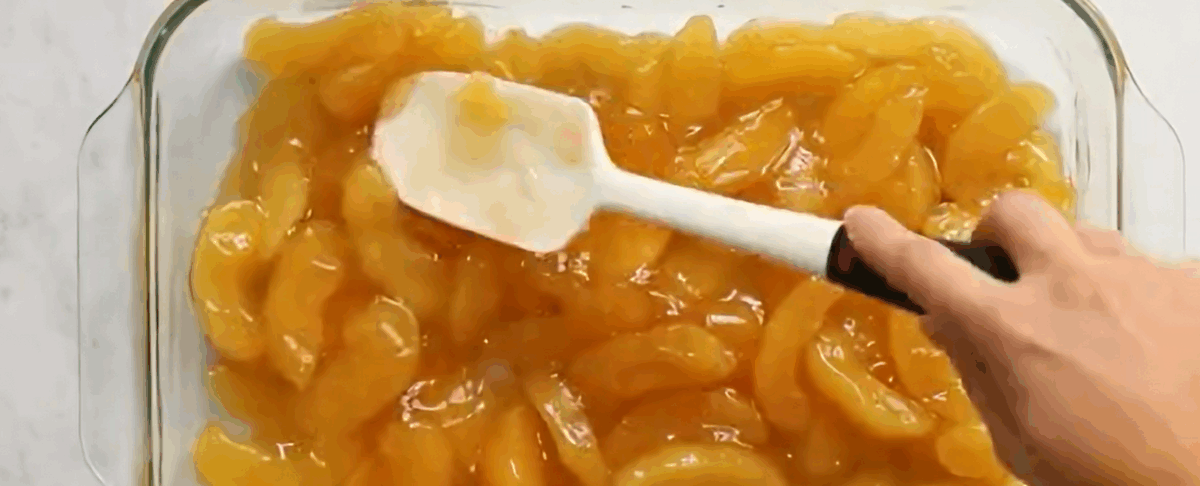 Apple pie filling in a glass baking dish.