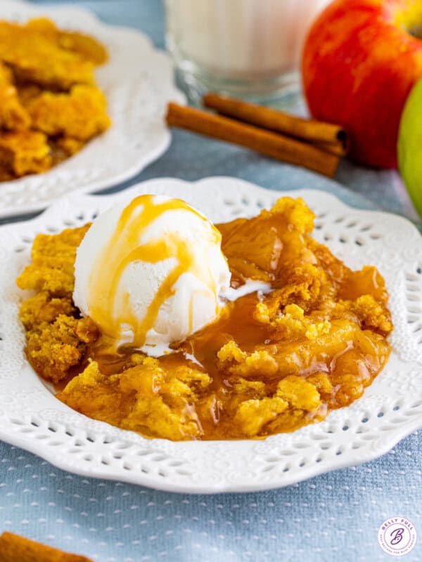 Serving of caramel apple dump cake in a white bowl.