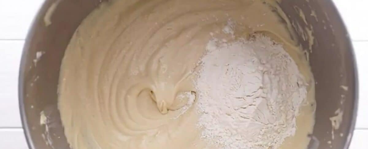 Adding half the dry ingredients with the buttermilk to the batter.