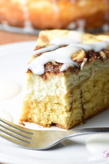 slice of cinnamon roll cheesecake with bite taken