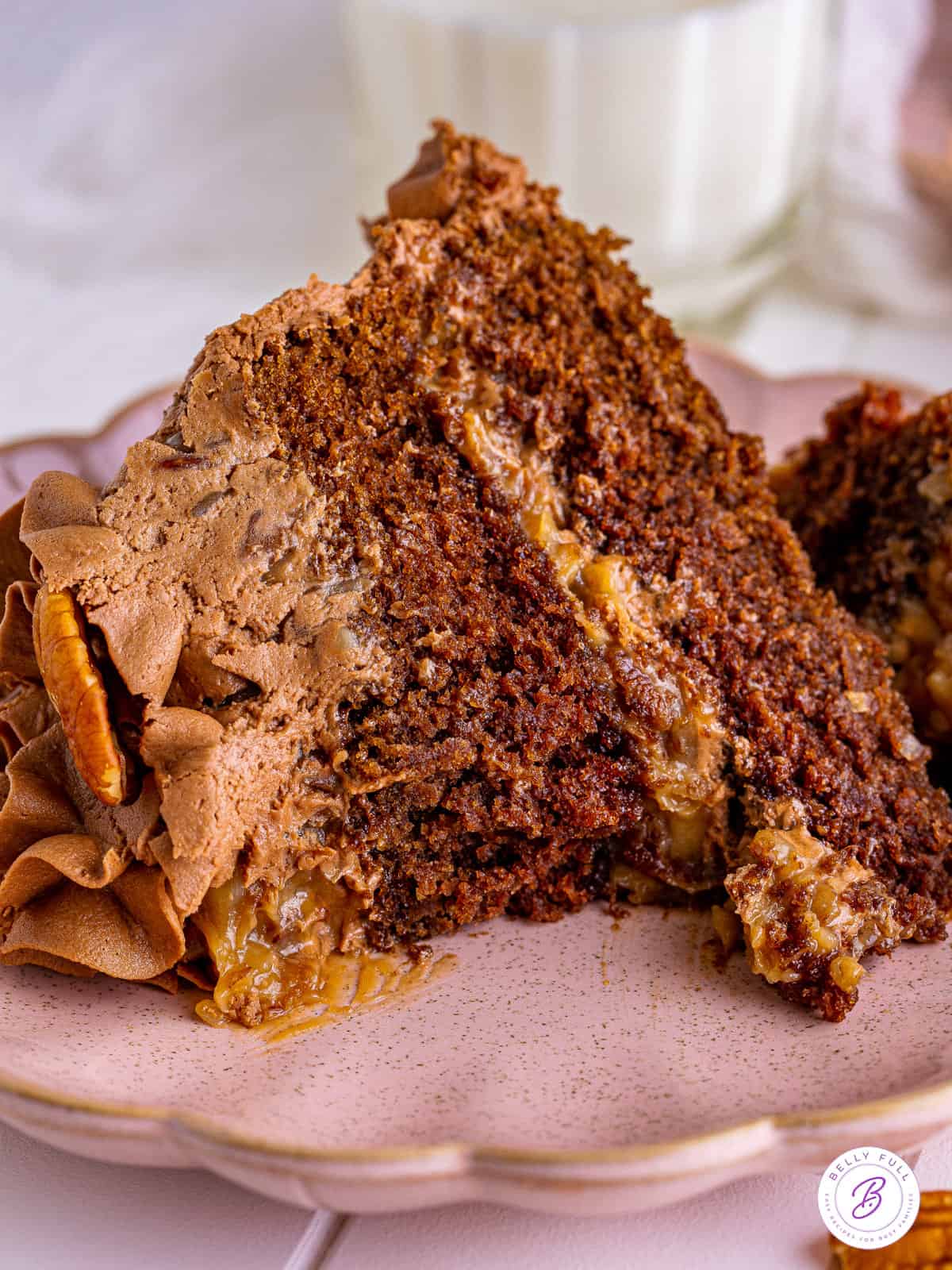 A slice of German chocolate cake with a bite missing