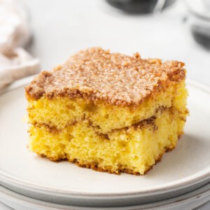 square slice of honey bun cake on white plate