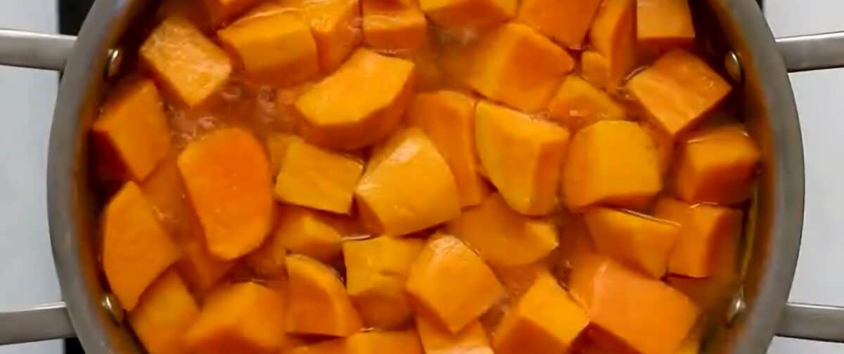 Sweet potato cubes in a pot with water.