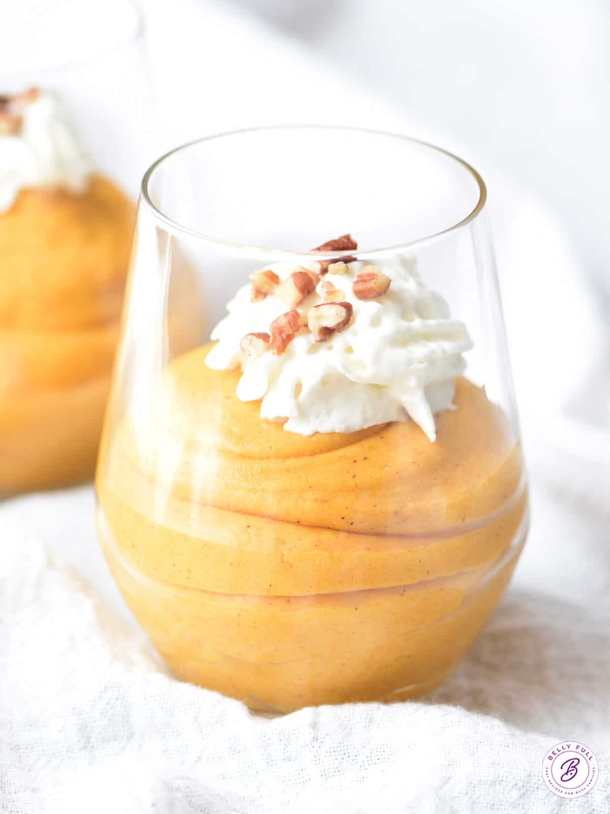 pumpkin fluff mousse in parfait glass with whipped cream and pecans