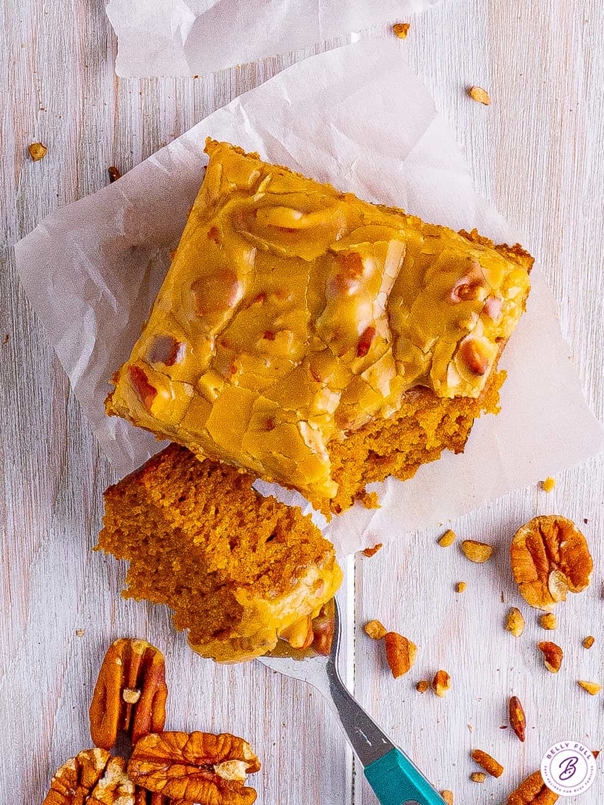 Overhead view of a pumpkin snack cake slice with a bite missing