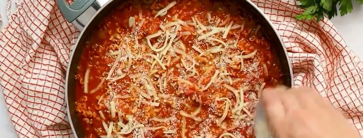 Adding mozzarella and Parmesan cheese.