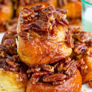 Several pecan sticky buns piled on a plate
