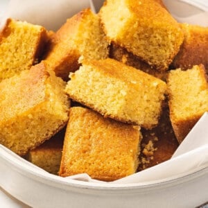 cut up portions of brown sugar cornbread in white bowl