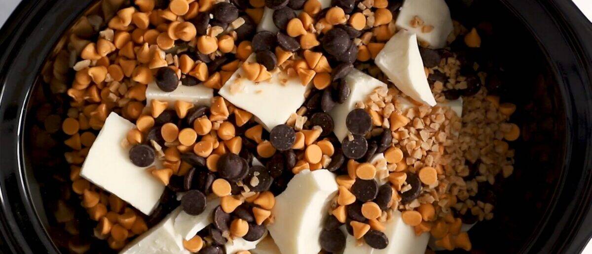 Ingredients to make crockpot candy layered in the crockpot. 